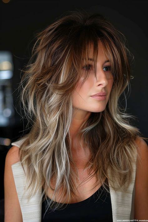 Woman with a layered shag haircut and soft balayage blending from warm brown to ashy blonde. Medium Hair Fringe Layers, Balayage On Shag Haircut, Original Shag Haircut, Long Shag Haircut Fine Hair Over 50, Shag Hairstyles Long Hair, Layered Shaggy Haircuts, Gentle Balayage, Hair Shaggy Layers, Modern Day Shag Haircut