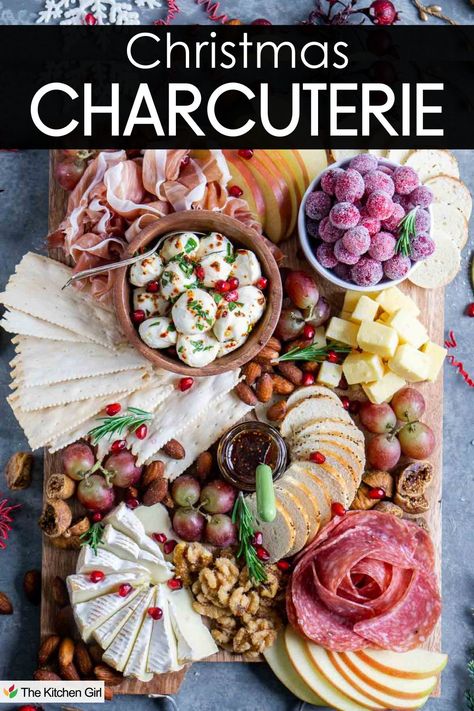 A festive charcuterie board featuring assorted meats, cheeses, crackers, nuts, grapes, sliced apples, and cranberries. The board is decorated with Christmas-themed items and the text at the top reads Christmas Charcuterie. Square Cheese Board, Charcuterie Jam, Easy Christmas Charcuterie Board, Cheeseboard Recipe, Cheese Christmas, Christmas Charcuterie Board, Charcuterie Meats, Christmas Charcuterie, Bagel Chips