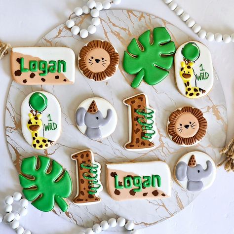 🦁 Go Wild for Your Little One’s First Birthday! 🦁 Celebrate your little one’s first birthday with our “Wild One” themed decorated cookies! Each cookie is meticulously crafted with fun and wild designs, perfect for adding a touch of adventure to your celebration. Make your celebration roar with our decorated cookies and let your little one’s special day be truly wild! 🦁🎂 #WildOneBirthdayCookies #JungleThemePartyTreats #FirstBirthdayWildOne #WildOnePartyFavors #CustomWildOneCookies #WildOneD... Wild One Cookies Decorated, Wild One Sugar Cookies, Wild One Birthday Cookies, One Birthday Cookies, Safari Cookies, Wild One Birthday, 1st Birthday Party Themes, Jungle Safari, Jungle Theme