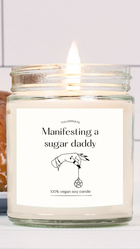 A candle in a glass jar. The candle is lit. The label on the candle reads: Manifesting a Sugar Daddy. It's a funny candle to give as a gift to friends and family. Cute Candle Names, Sassy Candles, Candle Labels Funny, Funny Candle Names, Funny Candle, Funny Candle Sayings, Candle Quotes Funny, Cricut Candles, Trendy Candle