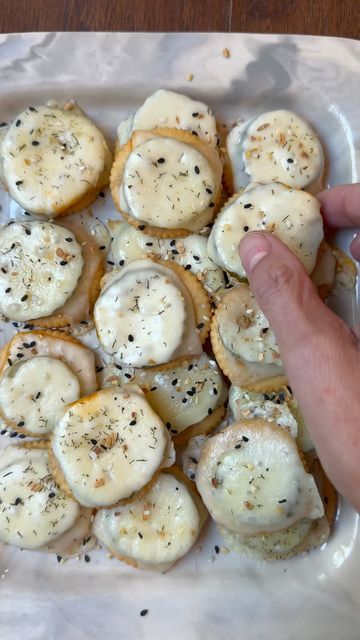 Natalie Mason on Instagram: "I have been dreaming about making these cheesy ritz pickle bites ever since I saw @food52 share @jessiesheehanbakes recipe.  A buttery ritz cracker topped with a zesty pickle slice and then baked with cheese yes please! 

I made these twice and I will say I recommend patting the pickles with a paper towel before placing on the ritz crackers this helps ensure the crackers don’t get soggy!  Try this 3 ingredient appetizer and let me know what you think! Would be perfect for game day! 

CHEESY RITZ PICKLE BITES 

Ritz crackers 
Sliced pickles I love @grillospickles 
Sliced cheese I did a mix of havarti and Muenster 
Optional toppings-
Trader Joe’s Pickle Seasoning 
EBB seasoning 

Layer the ritz on parchment paper and top with dried pickles and cheese.  Bake at 35 Ritz Cracker Pickle Cheese, Ritz Cracker Pickle, Ritz Pickle Cheese, Pickle Crackers, Garlic Bread Ritz Crackers, Pickle Cookies, Dill Pickle Cheez Its, Addicting Baked Seasoned Ritz Crackers, Pickle Bites