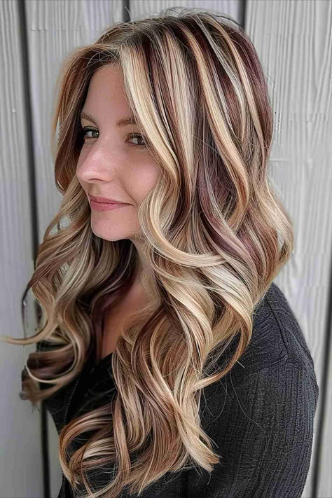 Wavy hair with chunky blonde highlights and lowlights. Fall Hair Colors Chunky Highlights, Long Hair With Highlights And Lowlights, Multi Dimensional Blonde Highlights, Blonde Hair With Brown And Red Lowlights, Red Blonde And Brown Highlights, Blonde With Maroon Highlights, Chunky Low Lights On Blonde Hair, Blonde Hair With Brown Highlights Chunky, Red Brown Blonde Highlights