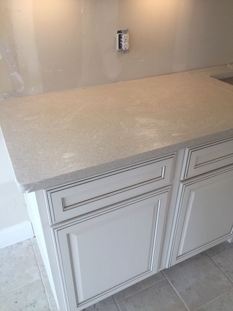 White cabinets with charcoal glaze and blanco city siltstone quartz countertops Reclaimed Kitchen, Glazed Kitchen Cabinets, White Kitchen Sink, Countertop Colours, Island Countertops, White Kitchen Design, Kitchen Upgrades, White Modern Kitchen, Girls Bathroom