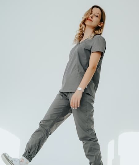 If you’re wearing scrubs almost daily, you definitely need to know all the best options for what to wear under scrubs. Scrubs are usually required for sanitary reasons for medical professionals and healthcare workers, or… The post What To Wear Under Scrubs: The Ultimate Guide appeared first on Fit Mommy In Heels. Shoes To Wear With Scrubs, Med Couture Scrubs, Suits And Sneakers, How To Dye Shoes, Scrubs Outfit, Long Sleeve Layer, Mommy Workout, Black Scrubs, Compression Tights