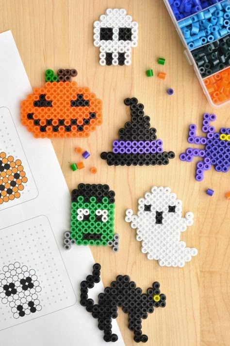 These Halloween Perler beads creations are so much fun to make! Follow our FREE, printable Halloween Perler bead patterns, or design your own Halloween pixel art using fuse beads! It's such a fun kids craft and activity, and you can easily make these Halloween Perler beads into a keychain or magnet for an awesome homemade gift. Perfect for birthday parties, sleepovers, or a rainy fall day! Halloween Iron Beads, Fall Perler Bead Patterns, Peeler Beads Patterns Easy, Halloween Hama Beads, Halloween Perler Bead Patterns, Halloween Perler Beads, Halloween Perler, Rave Ideas, Rainy Fall