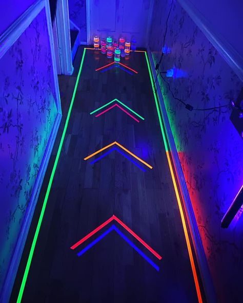 Mum turns her hallway into a glow-in-the-dark bowling alley using water bottles and Amazon bargains Glow In The Dark New Years Eve Party, Glow Party Floor Design, Glow In The Dark Gamer Party, Glow In The Dark Lights, Neon Glow In The Dark Party Ideas Food, Glow In The Dark Outfit Ideas Neon, Neon Glow Party Games, Neon Party Ideas Games, Glow Party Entrance