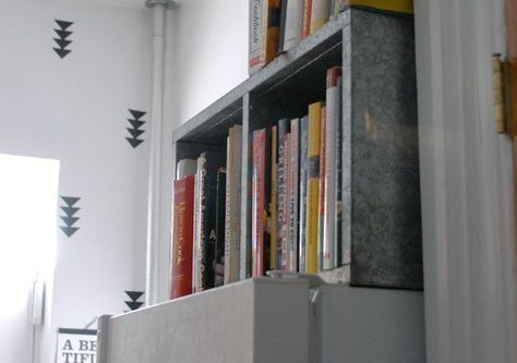 Steel bookcase on its side above the fridge to hold cookbooks--clever solution and use of that awkward space above the fridge. Cookbooks On Top Of Fridge, Cookbook Storage Above Fridge, What To Do With Space Above Refrigerator, Shelf For Side Of Fridge, Storage Above Fridfe, Over Fridge Ideas, Organize Cookbooks, Space Above Refrigerator, Above Refrigerator Storage