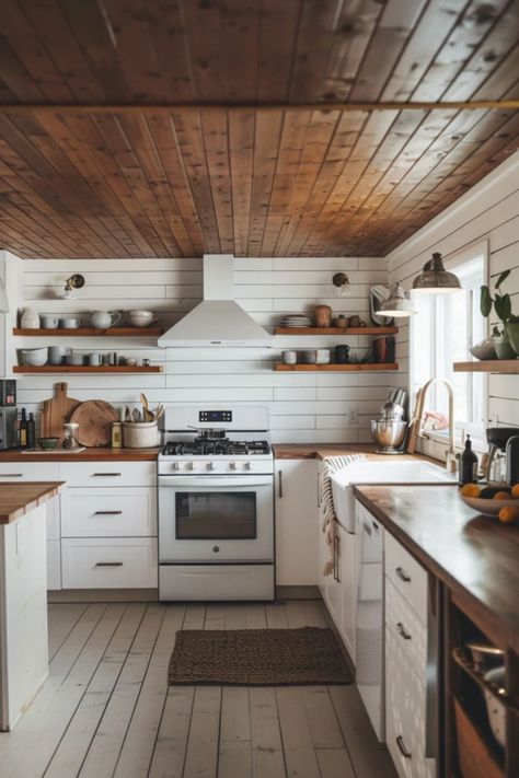 If you're looking to revamp your kitchen, why not consider adding a stunning shiplap ceiling? This design trend introduces a level of farmhouse charm or modern sophistication that'll make your space irresistible. From traditional white for a timeless appeal to bold, dark wood adding a dramatic flair, the possibilities are endless. Perfect for DIY enthusiasts or homeowners looking to enhance their kitchen ambiance, these shiplap ceiling ideas bring warmth and texture to every meal. Explore these stylish ideas and get inspired! Wood Ceilings Farmhouse, Wooden Ceiling In Kitchen, Kitchen With Wooden Ceiling, Natural Wood Shiplap Ceiling, Cedar Ceiling Kitchen, Wooden Ceiling Kitchen, Shiplap Kitchen Ceiling, Beadboard Ceiling Kitchen, Kitchen With Wood Ceiling