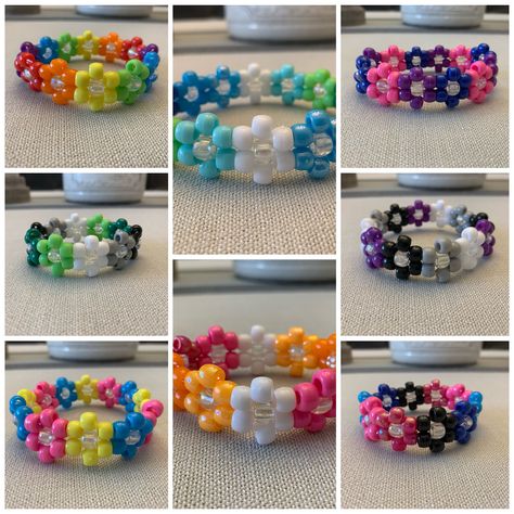 A Pride Flower kandi cuff that fits most wrists with clear stretchy string Flower Cuff Kandi Tutorial, Flower Cuff, Kandi Flower Cuff, Things To Make With String, Kandi Flower, Pride Kandi, Kandi Cuffs, Kandi Patterns Cuff, Bracelets Kandi