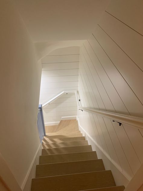 White Shiplap staircase will brighten up a basement. Staircase Design Basement, Shiplap Basement Stairwell, Shiplap Basement Walls, Basement Handrail, Shiplap Basement, Shiplap Staircase Wall, Beach House Staircase, Shiplap Stairwell, Shiplap Staircase