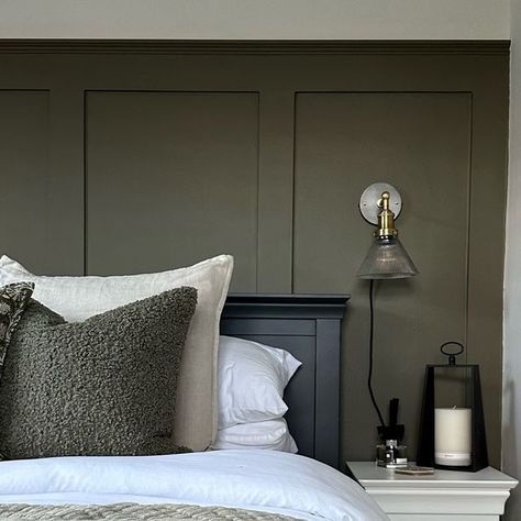 Courtney  |  Home interiors & renovations on Instagram: "New interior obsession for 2024… dark moody paint colours🖤  Where froms: • Panelling colour - colour match to F&B Cardamom (RAL 0954010) • Panelling colour - F&B Ammonite (colour matched by @decoratingcentreonline ) • Bed - @cotswoldco  • Wall lights - @industville  • Cushions - @dunelmuk (beige) @tkmaxxuk (green boucle) @vincentdaviesdepartmentstore (green pattern) • Throws - @hmhome (green) @dusk.com (beige) • Rug - @homesense_uk  • Lantern - old @bm_stores" Dark Green Panelled Wall, Green Feature Wall Bedroom Ideas, Dark Panel Bedroom, Green Bedroom Wall Panelling, F&b Setting Plaster, Dark Bedroom Panelling, Olive Green Bedroom Panelling, Dark Panelling Bedroom, Olive Green Panelling