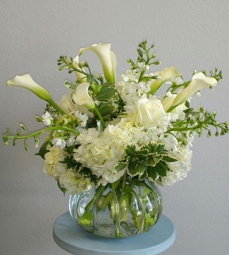 All White floral arrangement using Hydrangea, Calla Lilies, Stock, roses... Cala Lilies Arrangement, Hydrangea And Calla Lily Centerpiece, Lily And Hydrangea Arrangement, Calla Lily Floral Arrangements, Calalilly Centerpiece, Lilly Flower Arrangements, Calla Lillies Centerpieces, Calla Lily Wedding Centerpiece, Calla Lily Arrangement