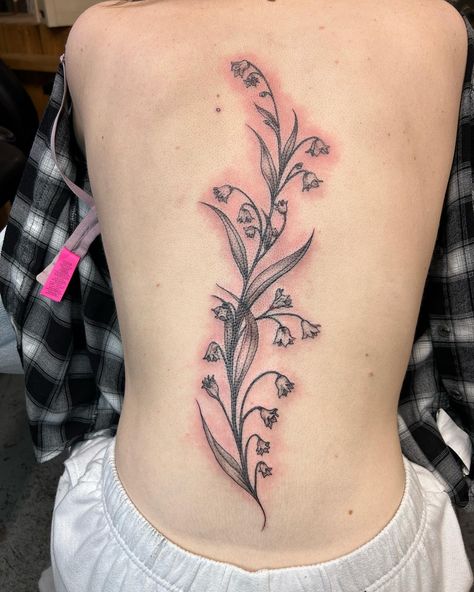 Delicate fine line spine tattoo done by @colleenajsmith! The beautiful flowers look so good in that perfect spot!! 😍⁠ ⁠ "She’s a little spicy looking, but here is an organic free flowing spinal tattoo that is comprised entirely of Lilies of the Valley. A healing flower which in the Ancient Roman tradition, had magical healing properties and the power to incant the spirits of those past beyond." - Colleen⁠ Spine Tattoos Lily Of The Valley, Tattoo Ideas Lily Of The Valley, Spine Tattoo Traditional, Lily Of The Valley Tattoo Spine, Flower Spinal Tattoo, Lily Of The Valley Back Tattoo, Lily Of The Valley Spine Tattoo, Lily Spine Tattoo, Nature Spine Tattoo