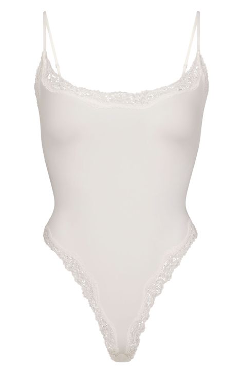 From Kim Kardashian's iconic SKIMS comes this lace-trimmed bodysuit with a scoop neck and sultry high legs. Adjustable straps 89% nylon, 11% spandex Machine wash, tumble dry Imported White Tops Aesthetic, White Lace Bodysuit, Body Suits, Cami Bodysuit, Simple Fits, Body Suit Outfits, Scooped Neckline, Corded Lace, Lace Camisole