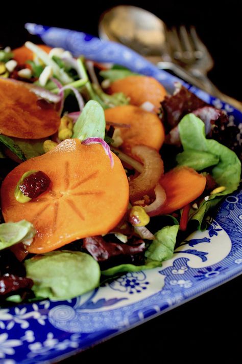 Persimmon Salad with Honey Pistachios is as delicious as it is beautiful! With blue cheese and cranberries in the mix, this colorful dish is perfect for the holiday season. #salad #fuyupersimmons #persimmons #bluecheese #pistachios Persimmon Salad, Truffle Recipe Christmas, Creamy Balsamic Dressing, Persimmon Recipes, Persimmon Fruit, Holiday Salads, Cranberry Pistachio, Salad Salad, Colorful Dishes