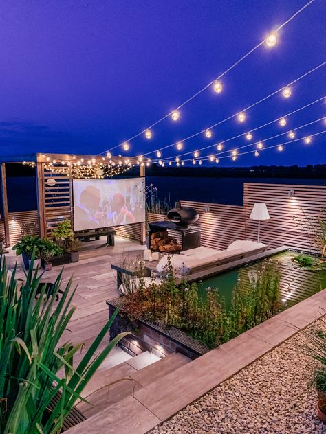 If you are on a budget, you could use a second-hand slide screen, the kind used in schools in the Eighties and Nineties, or pick up a projector screen from around £25 on Amazon. The lifestyle blogger Olivia Edwards-Silk (@lustliving) uses one in a wooden pergola in her garden for alfresco cinema nights. Brook uses an outdoor screen from Elite Screens’ Yard Master range — it has a folding aluminium frame and sturdy T-legs. Expect to pay about £200 for one of these, depending on the size. Rooftop Patio Design, Outdoor Cinema, Outdoor Screens, Rooftop Terrace Design, Rooftop Design, Outdoor Projector, Rooftop Patio, Outdoor Gardens Design, Outdoor Movie