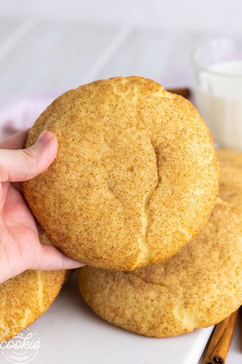 a hand holding a cookie made with a soft snickerdoodles recipe. The cookie is extra large. Jumbo Cookie Recipe, Thick Snickerdoodle Cookies, Soft Snickerdoodles, Cookies Crumbl, Fun Cookie Recipes, Soft Snickerdoodle Cookies, Snickerdoodles Recipe, Thick Cookies, Snickerdoodle Recipe