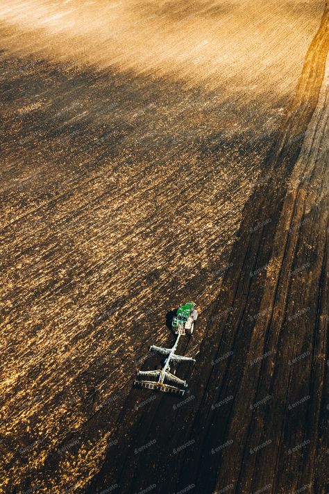 Aerial View. Tractor Plowing Field In Spring Season. Beginning Of Agricultural Spring Season, Photos - Envato Elements Plowing Fields, Dusk Time, Tractor Plow, Clock Tower, Envato Elements, New Shows, Top View, Spring Season, Aerial View