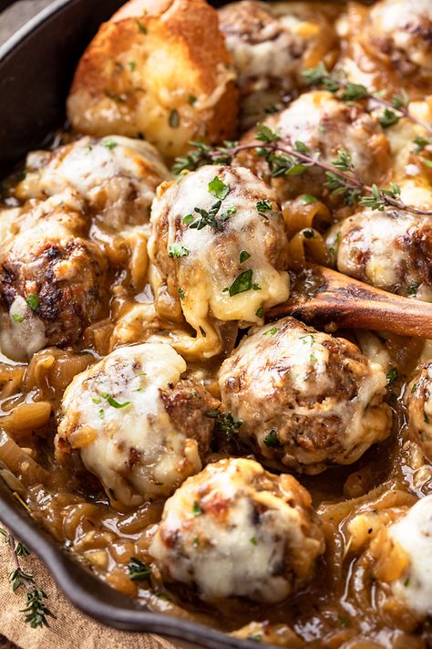 These French onion meatballs are nestled into a rich, savory onion sauce kissed with sherry, then topped with Gruyere and mozzarella cheeses! | thecozyapron.com #frenchonionmeatballs #frenchonionmeatballsrecipe #frenchonionmeatballseasy #frenchonionmeatballsbaked Crockpot French Onion Meatballs, French Onion Beef Meatballs, French Onion Meatballs Baked, Sunchips French Onion Meatballs, French Onion Soup Meatballs, French Onion Meatball Skillet, Slow Cooker French Onion Meatballs Ina, French’s Onion Chicken, French Onion Meatballs Recipe