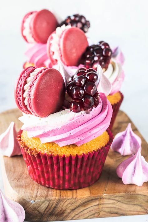 Pomegranate Cupcakes vanilla cupcakes, filled with pomegranate jam, frosted with Swiss Meringue Buttercream, topped with a pomegranate macaron and meringue cookies #pomegranate #cupcakes #macarons #pomegranatedesserts #valentinesday #pinkfood #pinkcupcakes #pink #lovecupcakes #decoratedcupcakes Pomegranate Cupcakes, Pomegranate Jam, Cupcakes Vanilla, Fruit Cupcakes, Cupcakes Filled, Party Food Dessert, Dessert Party, Meringue Buttercream, Cupcake Flavors