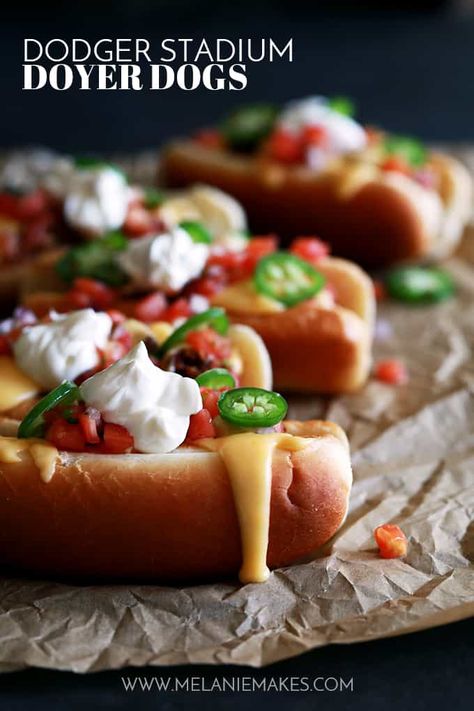 My Dodger Stadium Doyer Dogs are like bringing the ballpark home, but with a more flavorful punch!  This hot dog is nestled in a pillowy bun before being covered with my Beer Braised Beanless Chili, Beer Cheese Fondue, pico de gallo, sour cream and sliced jalapeños. Gourmet Hot Dogs Toppings, Beer Cheese Fondue, Gourmet Hot Dogs, Hot Dog Toppings, Sausage Sandwiches, Sausage Dishes, Cheese Dog, Hot Dog Recipes, Beer Cheese