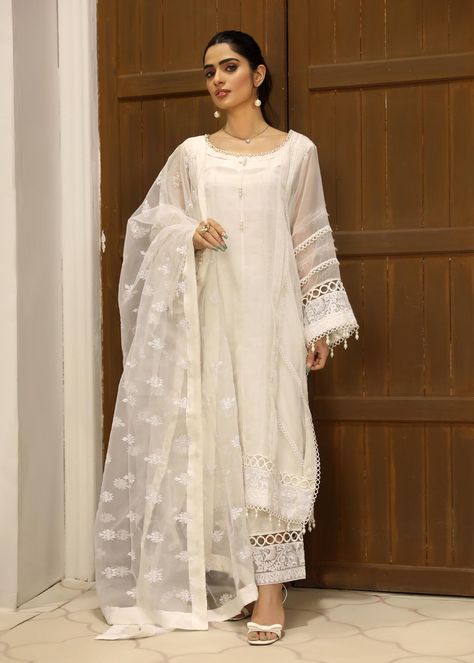 Includes: Shirt Trouser Dupatta Fabric: Organza Work Technique: embroidery Description: A splendid white organza shirt with pleating and raw edges details on it with inticate laces.it comes with white raw azzars with embroided border and edged with laces.It has beautiful organza dupatta with embroidered booti spray on it hem with silk finishing.This is 3 Piece Stitched outfit. Disclaimer: The color of the outfit may vary due to the lighting effect used in the photography. Kurta Ideas, Organza Suits, Pant Suits For Women, Organza Shirt, Shirt Trouser, Organza Top, Traditional Indian Dress, Pant Suits, Desi Style