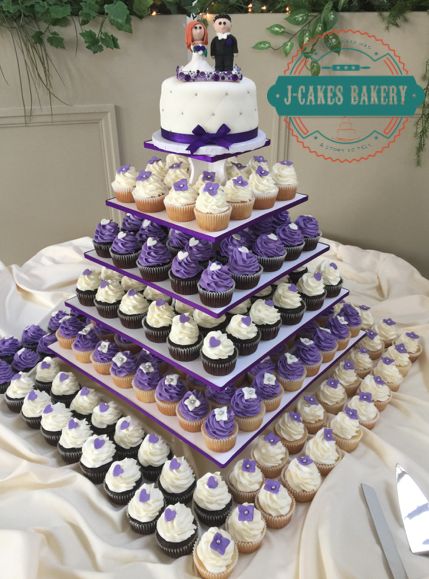 Wedding Cupcakes Ideas Purple, 2 Tier Cake With Cupcakes, Cupcake And Wedding Cake Display, Wedding Cupcake Cake Ideas, Cupcake Towers Wedding, Cupcake Wedding Display, Wedding Cupcakes Ideas, Purple Wedding Cupcakes, Wedding Cake With Cupcakes