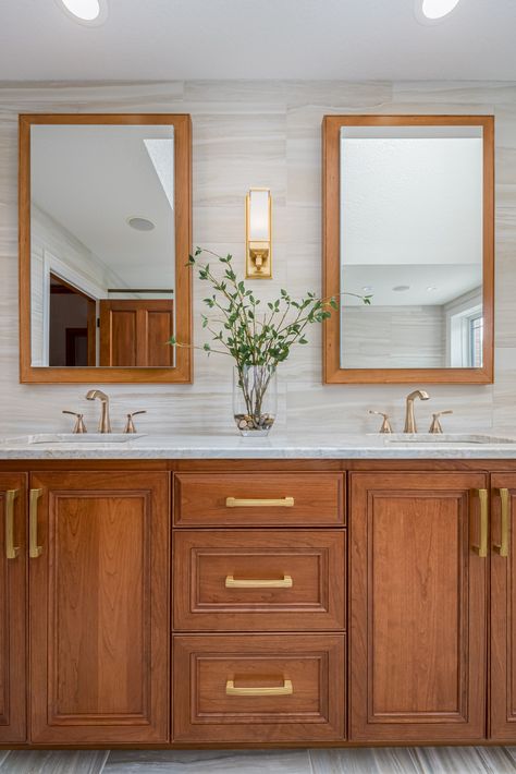 Double vanity cabinet in natural-finish cherry wood with recessed medicine cabinets and custom matching frames. Medium Brown Bathroom Vanity, Bathroom With Wooden Cabinets, Red Oak Bathroom Vanity, Wood Cabinet Bathroom Ideas, Dark Wood Double Vanity, Cherry Cabinet Bathroom, Cherry Cabinets With Gold Hardware, Cherry Vanity Bathroom, Cherry Wood Bathroom Vanity