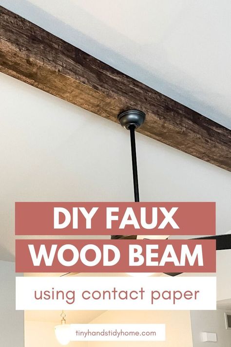 A living room with a rustic wood beam and ceiling fan. The text over the image reads, "DIY faux wood bean using contact paper". Living Room With Beams On Ceiling, Fake Wood Beams, Faux Ceiling Beams, Wooden Beams Ceiling, Fake Wood, Woodworking Store, Faux Beams, Faux Wood Beams, Wood Beam