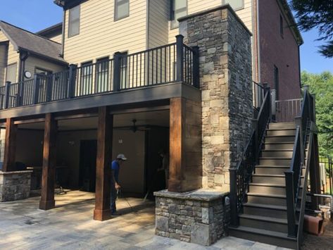 A stunning pool surrounded by a two-tier deck, featuring a cozy fireplace for a warm and inviting outdoor escape. Fireplace Under Deck, Two Tier Deck, 2nd Story Deck, Hot Tub Deck Design, Second Story Deck, Stone Porches, Deck Fireplace, Tiered Deck, Porch Fireplace