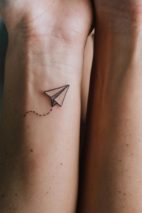 Paper airplane tattoo with dotted trail on a forearm. Airplane Tattoo Ideas, Black Ink Sketches, Women Tattoo Inspiration, Tattoo Ideas For Females, Airplane Tattoo, Airplane Tattoos, Small Airplanes, Cartoon Airplane, A Tattoo Design