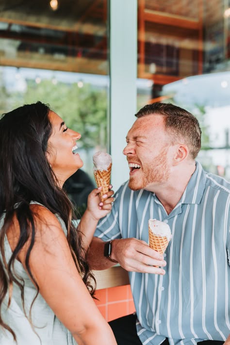 Couple laughing while holding their ice cream cones. Ice Cream Shop Photo Shoot Couple, Engagement Photos With Ice Cream, Ice Cream Maternity Photoshoot, Engagement Photos Ice Cream Shop, Ice Cream Maternity Shoot, Ice Cream Date Photoshoot, Ice Cream Parlor Photoshoot, Ice Cream Couple Photoshoot, Coronado Photoshoot