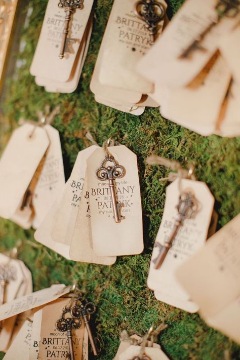 Wedding escort card idea. Vintage key bottle opener wedding favor on a moss-covered frame. #fairytalewedding #weddingfavors #escortcards #weddingideas Key Bottle Opener Wedding Favor, Fairytale Wedding Favors, Key Wedding Favors, Fairytale Wedding Theme, Oheka Castle, Wedding Bottle Opener Favors, Wedding Bottle Opener, Creative Wedding Favors, Inexpensive Wedding Favors