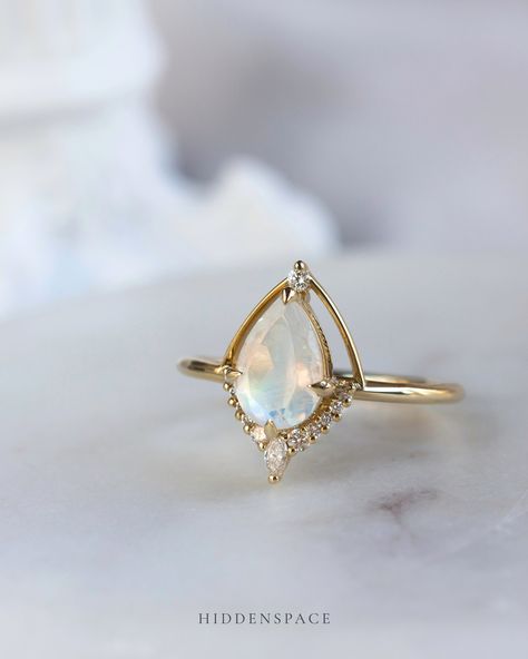 Here’s to a love story as enchanting as this moonstone. 💖🌙 #moonstoneengagementring #hiddenspacejewelry #moonstone #14kgoldengagementring #uniqueengagementring #customengagementring #oneofakindring #modernbride #weddingring #stackingrings Moonstone Engagement, Moonstone Engagement Ring, A Love Story, Custom Engagement Ring, Modern Bride, Moon Stone, Unique Engagement Rings, A Love, Moonstone