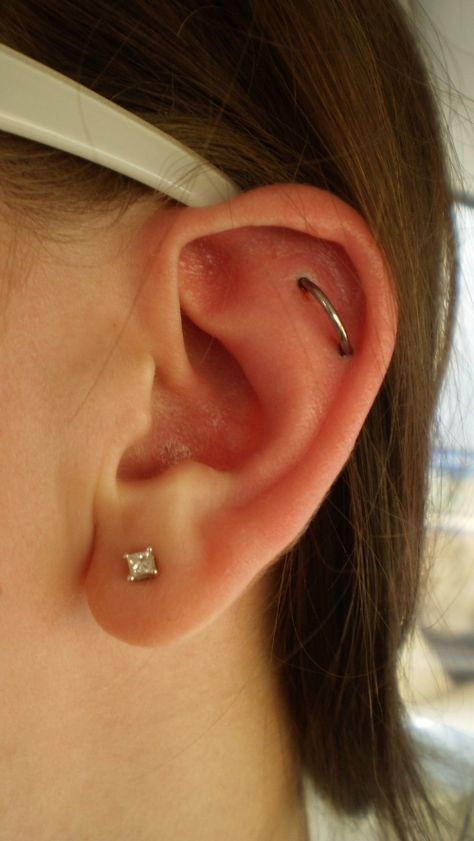 Helix Orbital Piercing - an orbital is an earring that goes through two parts of the ear Helix Orbital Piercing, Hip Piercings, Piercing Orbital, Orbital Piercing, Piercing Inspiration, Ear Peircings, Ear Piercings Chart, Double Ear Piercings, Ear Piercings Helix