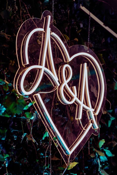 wedding neon sign with initials, heart, hanging, greenery backdrop, photo backdrop, reception decor Signs With Last Name, Name Sign For Wedding, Reception Sweetheart Table, Entrance Ceiling, Last Name Neon Sign, Backdrop Greenery, Greenery Arch, Neon Sign Ideas, Ideas For Yard