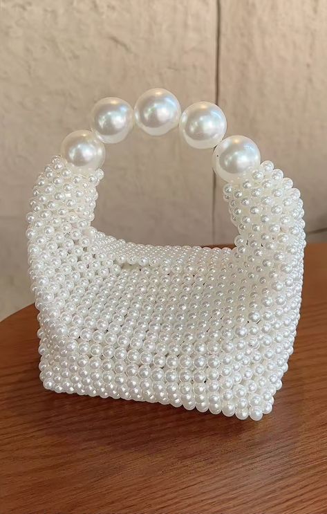 Add a touch of bridal charm to your look with the Penelope Bag! This cute little purse is adorned with shimmering pearls, adding a touch of sophistication to any outfit. Make every moment memorable with this chic accessory by your side! Pearl Bag Design, Pearls Purse, Bead Bags Designs, Hand Purse, Pearl Purse, Pearl Bags Purses, Beaded Purses Pattern, Bead Purse, Pearl Bags