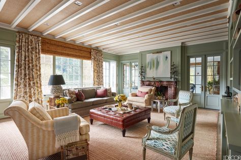 In an East Hampton home designed by Celerie Kemble, the living room's olive green walls complement the soft hues of the sofa and club chairs by Celerie Kemble for Henredon. The ottoman, by Bunny Williams Home, is covered in a Moore & Giles leather and the early-19th-century Louis XVI-style armchairs are upholstered in a Shyam Ahuja cotton. Rustic Chic Design, Sofas Vintage, French Country Interiors, Hampton Home, Country Style Interiors, French Country Living, Modern French Country, Tuscan Design, French Country Living Room