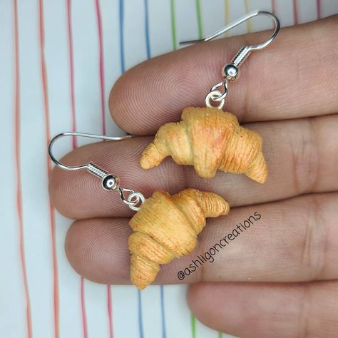 Croissant Earrings Croissants measure approximately between 1.5cm to 2.25cm Materials: ▫ Polymer Clay ▫ Hypoallergenic Hanging Earring Hook Each Croissant is handmade by me, so you may receive a pair of earrings that are slightly different from the ones pictured in the listing. As they are all made by hand all are similar but no two pairs will ever be the same! I can also do custom orders. Please feel free to send me a message with any questions or ideas! Thanks for checking out my shop! Polymer Clay Croissant, Polymer Food Earrings, Polymer Clay Inspiration, Fimo Ideas Jewelry, Cute Earrings Diy, Polymer Clay Food Earrings, Silly Earrings, Clay Earrings Cute, Croissant Earrings