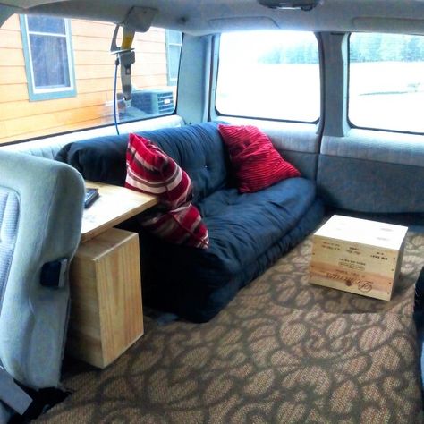 I turned the back of the Suburban into a living room! # chevy#suburban#chevysuburban#futon#budgetcamper#camper#cool#cozy#cute#recycled#inovative Chevy Suburban Camper Conversion, Chevy Suburban Camping, Suburban Camper Conversion, Chevy Suburban Interior, Suburban Conversion, Suburban Camper, Suburban Interior, Camper Lifestyle, Nomadic Living