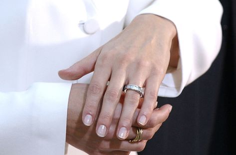 King Felipe of Spain and Queen Letizia | The non-traditional eternity band featured 16 diamond baguettes and a white gold trim. It was designed by Suarez jewelers. After the wedding, Letizia swapped the ring for a simpler band.   via @AOL_Lifestyle Read more: https://www.aol.com/article/lifestyle/2018/01/22/princess-eugenies-engagement-ring-is-almost-identical-to-mom-sarah-fergusons/23340516/?a_dgi=aolshare_pinterest#fullscreen Queen Letizia Wedding Ring, Zelda Fitzgerald Engagement Ring, Princess Eugenie Engagement Ring, Queen Leticia, The Princess Diaries 2: Royal Engagement, King Felipe Of Spain, After The Wedding, Simple Band, Sarah Ferguson