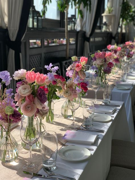 Long table with pink and purple bud vase centerpiece decor for wedding, bridal shower or luncheon. Planning and design by Lindsay Landman Events #weddingflowers #floral #centerpieceinspiration #budvasearrangements #floraltablerunner #pinkflowers #purpleflowers Vase Centerpiece Wedding, Long Table Decor, Pink Flower Centerpieces, Simple Floral Centerpieces, Bridal Shower Table Decorations, Bud Vase Centerpiece, Flower Table Decorations, Purple Bridal Shower, Bridal Shower Inspo