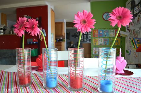 Colorful #Slinky used to add color in floral centerpieces Slinky Centerpiece, Valentine's Party, Mom Party, Spring Into Action, 80s Party, Toy Story Party, Valentines Party, Floral Centerpieces, 40th Birthday