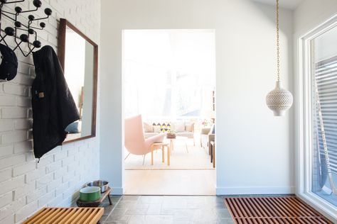 A classic Eames Hang-It-All (in black) and a George Nelson bench furnish the entryway. Entryway Organization Ideas, Eames Hang It All, Shoe Storage Drawers, Home Office Design On A Budget, Nelson Bench, Hang It All, Diy Wardrobe, Alphabet Crafts, Entry Way Design