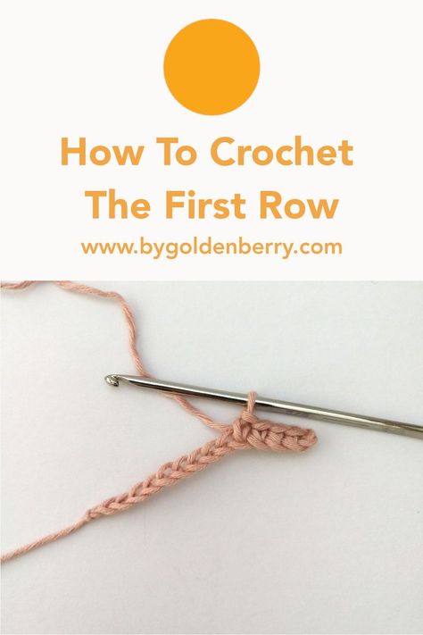 A photo of a foundation chain made in pastel pink yarn with a few of the first row of stitches made. The silver crochet hook is still attached to the loop. Above there is orange text which reads "How To Crochet The First Row" and "www.bygoldenberry.com" below that. The background is off white. Crochet First Row, How To Start 2nd Row Crochet, Crochet Second Row, How To Start Second Row Of Crochet, How To Start A Second Row Crochet, How To Start Crochet, Magic Circle Crochet, Crochet Chain Stitch, Foundation Single Crochet