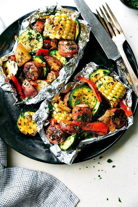 Easy Tin Foil Sausage and Veggies Dinner | Chelsea's Messy Apron Campfire Dinner Recipes, Tin Foil Meals, Vegetarian Camping Recipes, Camp Cooking Recipes, Camping Dessert Recipes, Tin Foil Dinners, Campfire Dinners, Foil Pack Dinners, Foil Packet Dinners