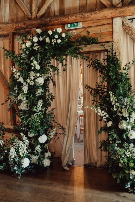 Foliage And White Flowers Wedding, Winter Wedding Floral Installation, Flowers On Beams Wedding, Foliage Arch Wedding, Greenery Florals Wedding, Foliage Wedding Arch, Greenery Heavy Wedding, Wedding Flower Installations, Broken Arch Wedding