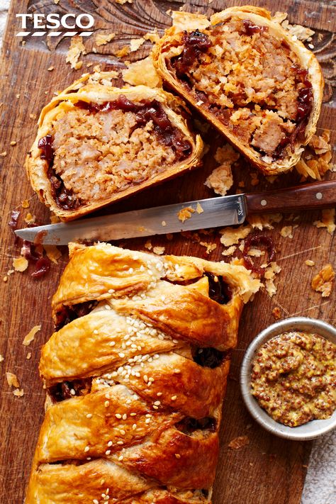 Feast your eyes and fill up on this better-sized sausage roll. A pretty plait of golden, crispy pastry filled with herby sausage meat and sweet caramelised onions makes this savoury showstopper the ideal centrepiece for any festive buffet. | Tesco Sausage Plait, Savoury Pastry, Caramelised Onions, Sausage Roll, Savoury Pies, Tesco Real Food, Savory Pastry, Savoury Baking, Onion Recipes