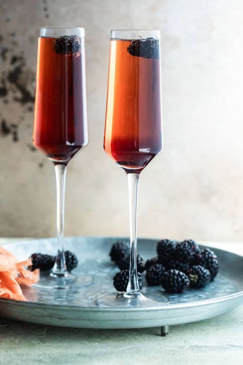 Two Kir Royale cocktails in champagne flutes on a metal tray. Kir Royale Recipe, Kir Royale Cocktail, Recipes For A Party, French Cocktails, Kir Royale, Raspberry Liqueur, Raspberry Tarts, Copycat Restaurant Recipes, Circle Bag