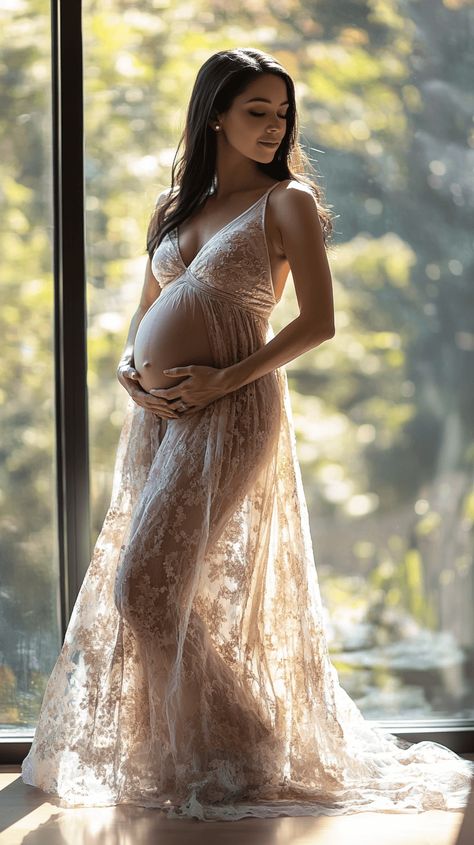 Realistic photo of a pregnant woman standing by a large window, softly backlit by natural sunlight, gently holding her baby bump with both hands, wearing a flowing dress, with a peaceful and serene expression on her face. Healthy Pregnant Woman, Bump Shoot, Maternity Studio, A Pregnant Woman, Mom Lifestyle, Flowing Dress, Large Window, Flowing Dresses, Pregnant Woman